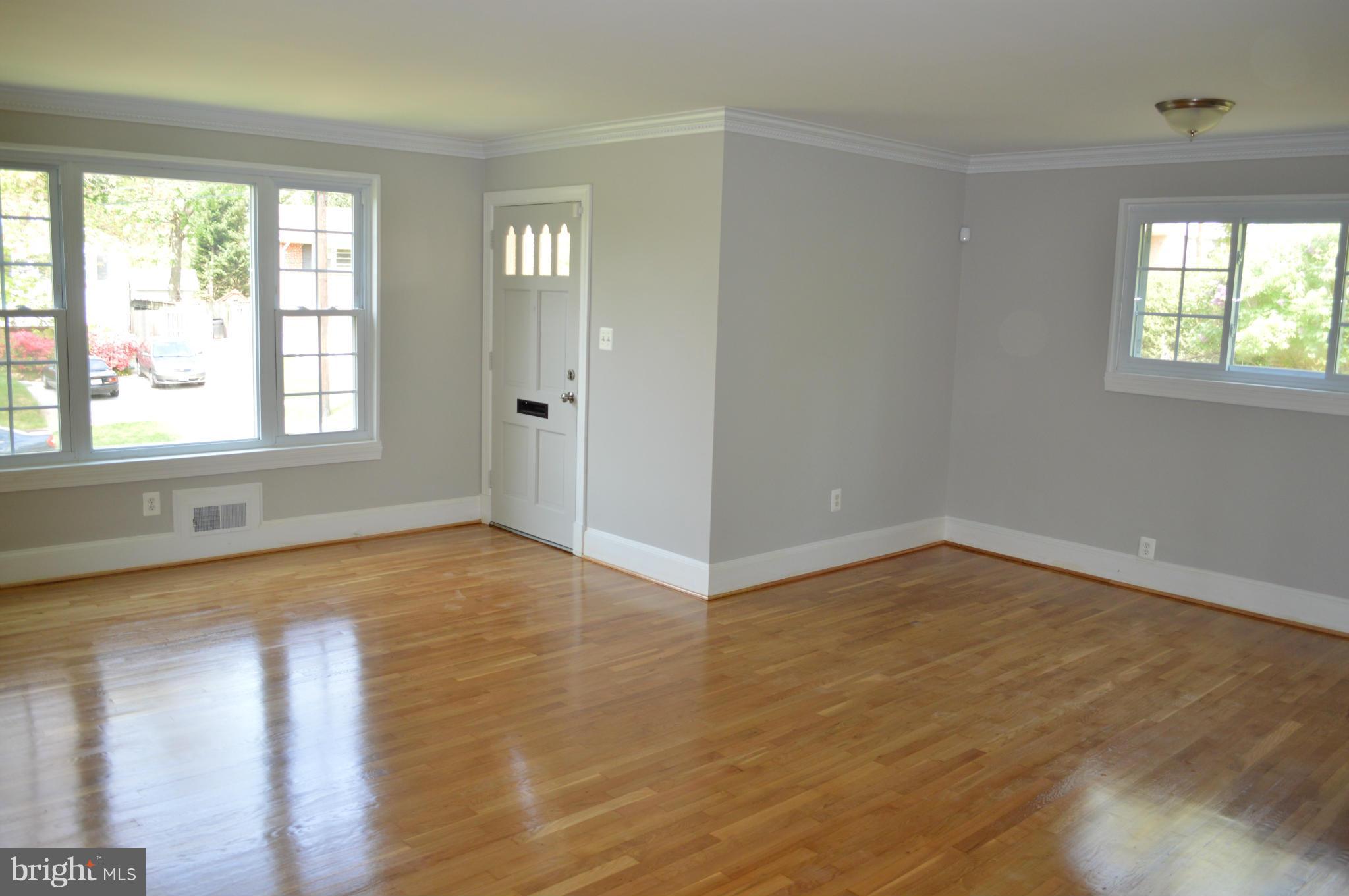 4238 Isbell Street Silver Spring, MD 20906 - Photo 4 of 22 a view of an empty room with wooden floor and a window
