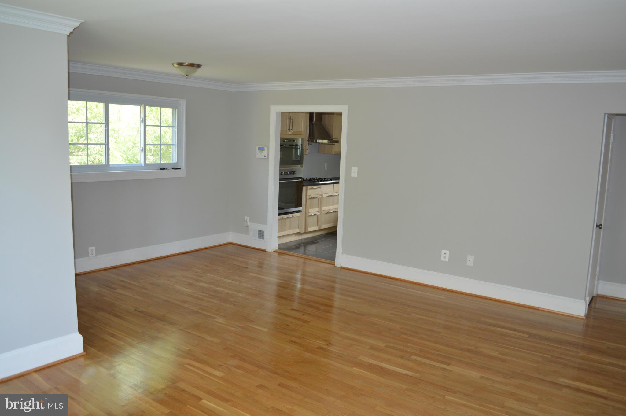 4238 Isbell Street Silver Spring, MD 20906 - Photo 5 of 22 wooden floor in an empty room with a window