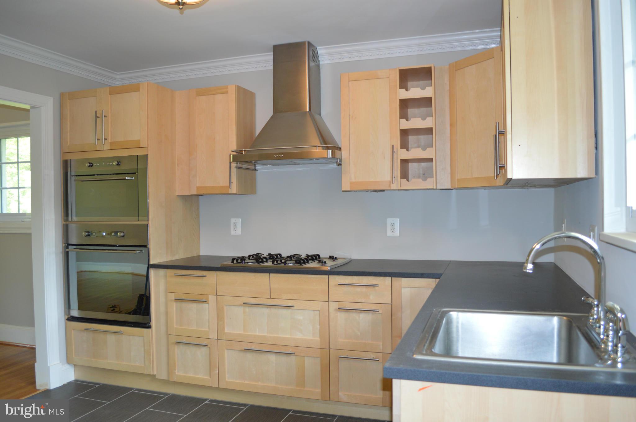 4238 Isbell Street Silver Spring, MD 20906 - Photo 6 of 22 a kitchen with granite countertop a sink and a stove