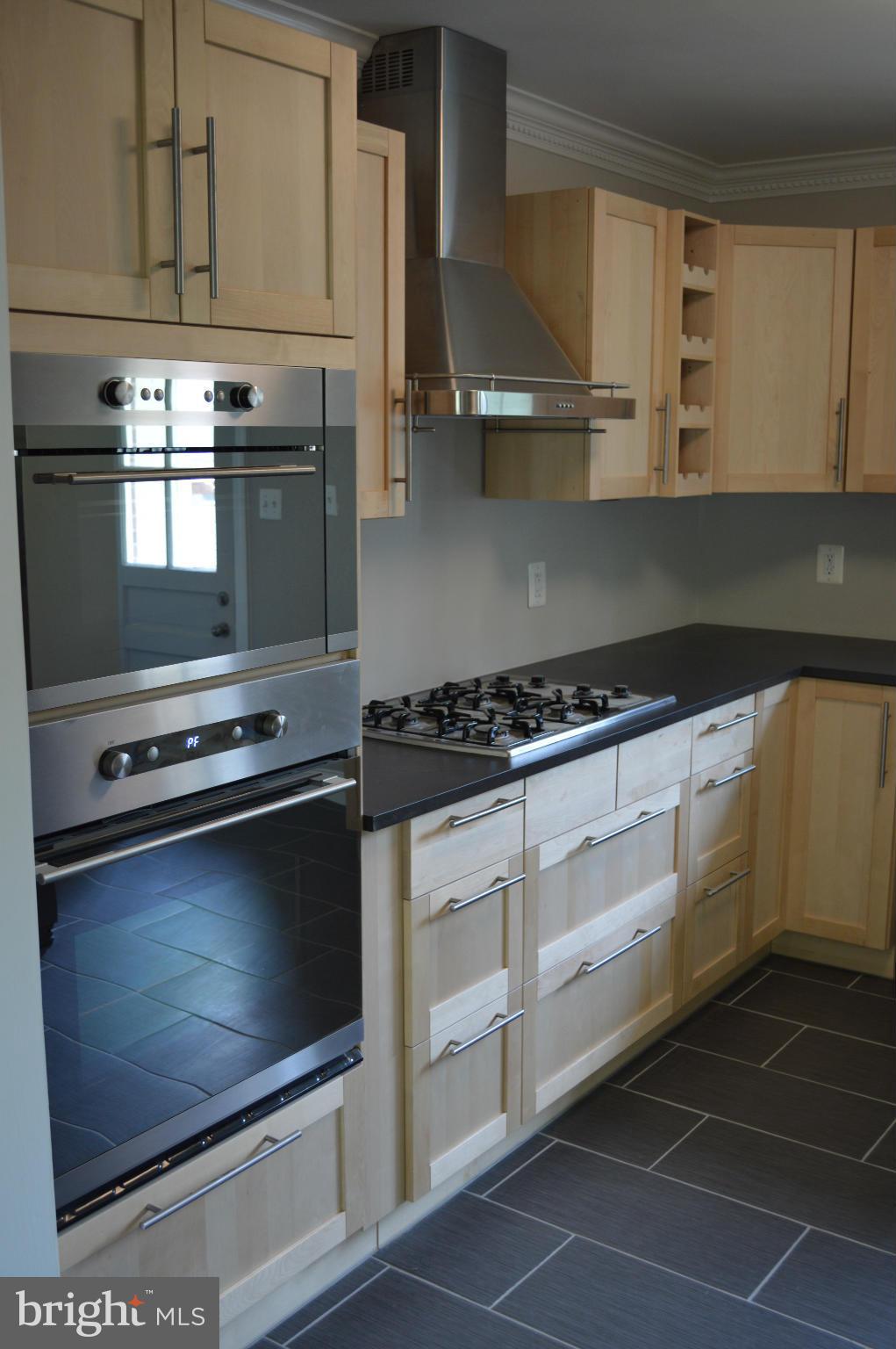 4238 Isbell Street Silver Spring, MD 20906 - Photo 7 of 22 a kitchen with granite countertop white cabinets and appliances
