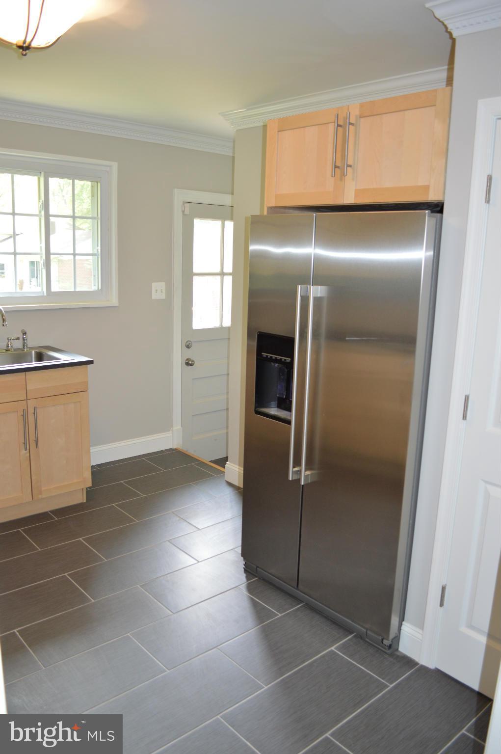 4238 Isbell Street Silver Spring, MD 20906 - Photo 8 of 22 a kitchen with granite countertop a refrigerator and a stove