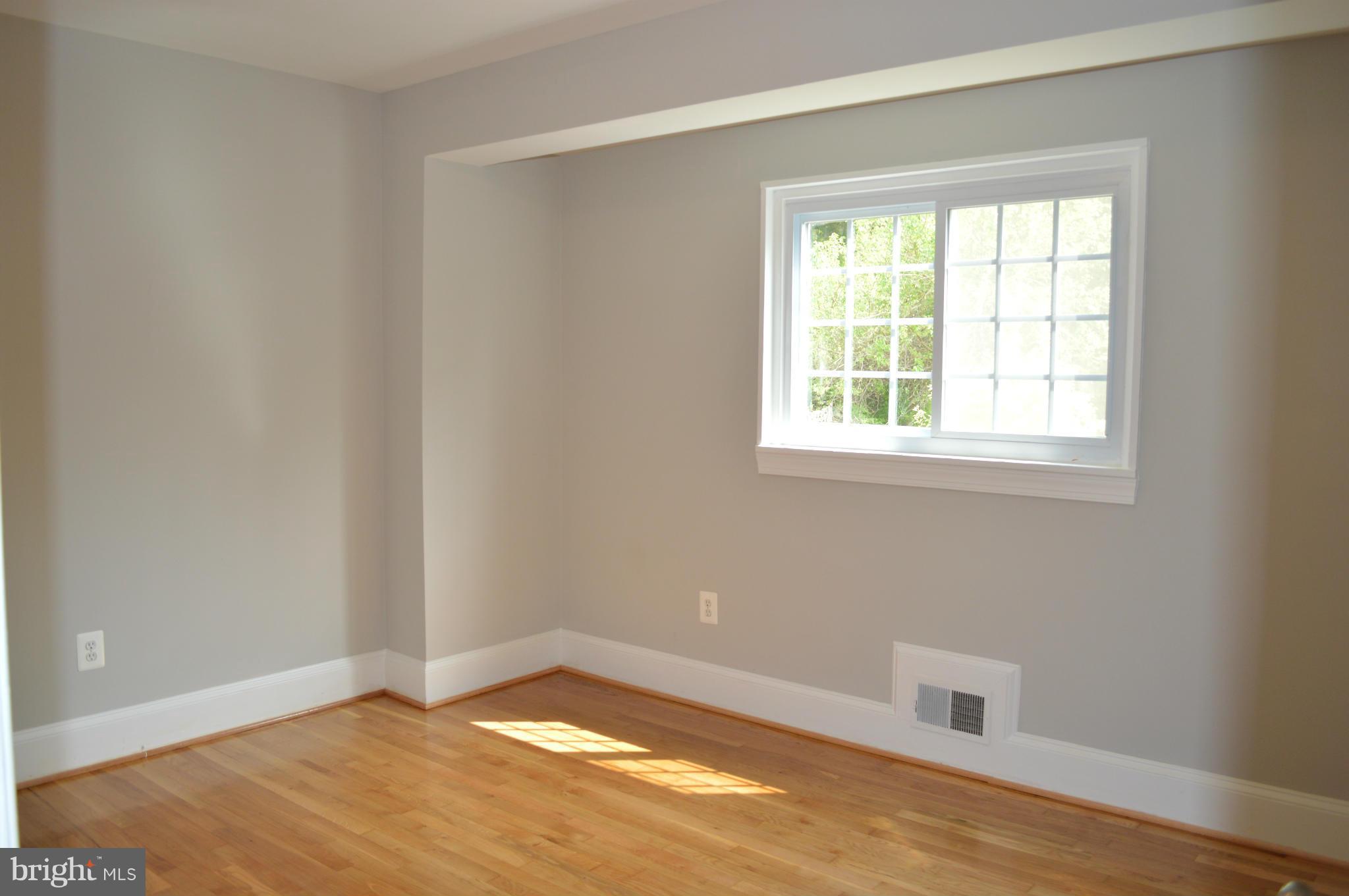 4238 Isbell Street Silver Spring, MD 20906 - Photo 10 of 22 an empty room with wooden floor and windows