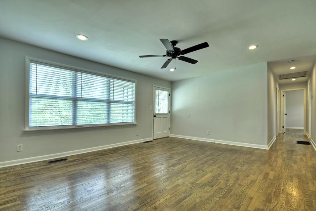 870-868 Sugar Creek Road Blue Ridge, GA 30513 - Photo 14 of 84 a view of empty room with wooden floor and fan