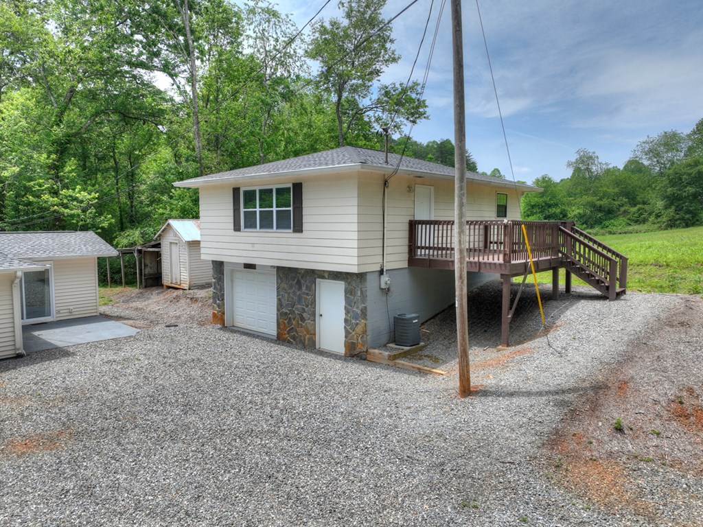 870-868 Sugar Creek Road Blue Ridge, GA 30513 - Photo 17 of 84 a view of a house with a backyard and a tree