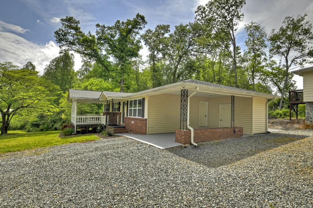 870-868 Sugar Creek Road Blue Ridge, GA 30513 - Photo 24 of 84 a backyard of a house with barbeque oven table and chairs