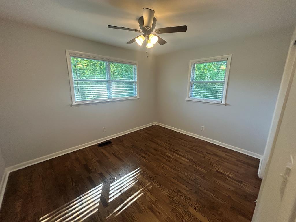 870-868 Sugar Creek Road Blue Ridge, GA 30513 - Photo 26 of 84 a view of an empty room with wooden floor and a window