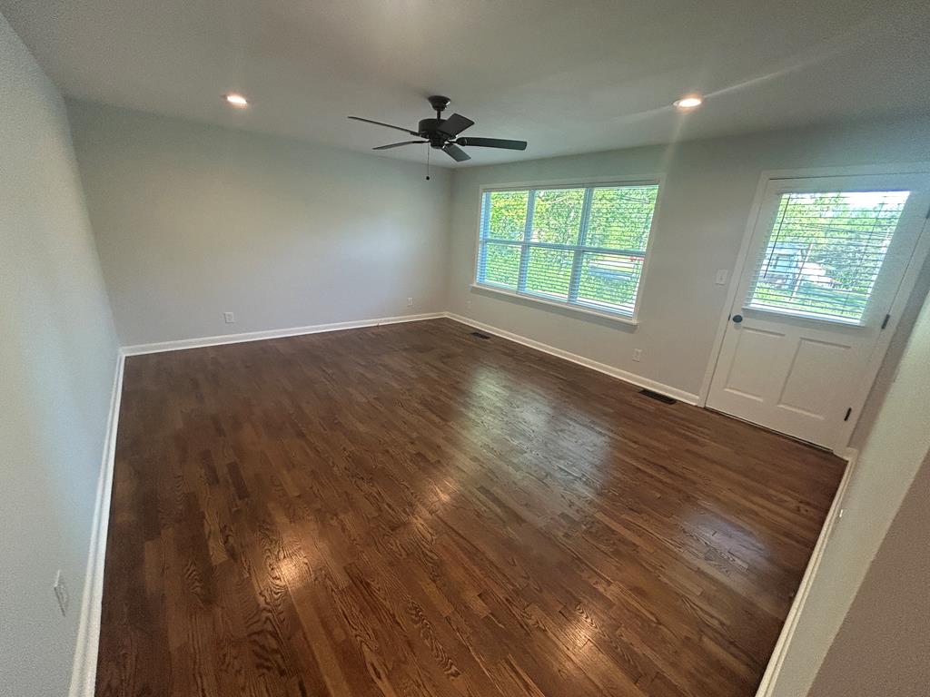870-868 Sugar Creek Road Blue Ridge, GA 30513 - Photo 4 of 84 an empty room with wooden floor fan and windows