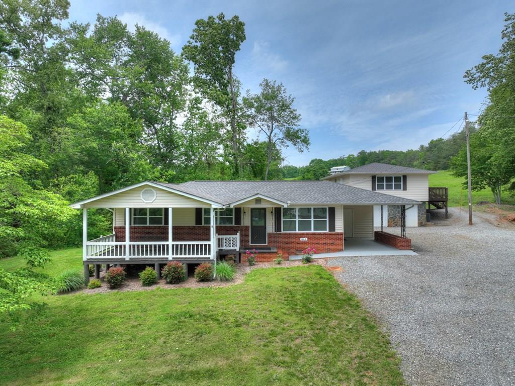 870-868 Sugar Creek Road Blue Ridge, GA 30513 - Photo 5 of 84 a front view of a house with a yard and trees
