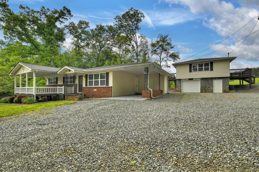 870-868 Sugar Creek Road Blue Ridge, GA 30513 - Photo 52 of 84 a view of a house with a yard and sitting area