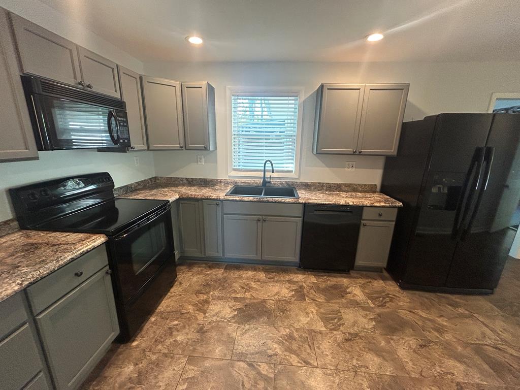 870-868 Sugar Creek Road Blue Ridge, GA 30513 - Photo 68 of 84 a kitchen with stainless steel appliances granite countertop a sink stove and refrigerator
