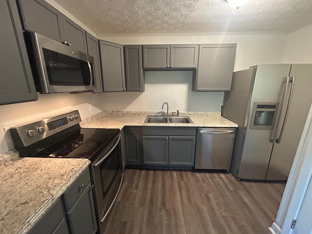 870-868 Sugar Creek Road Blue Ridge, GA 30513 - Photo 7 of 84 a kitchen with a sink a microwave a refrigerator and cabinets