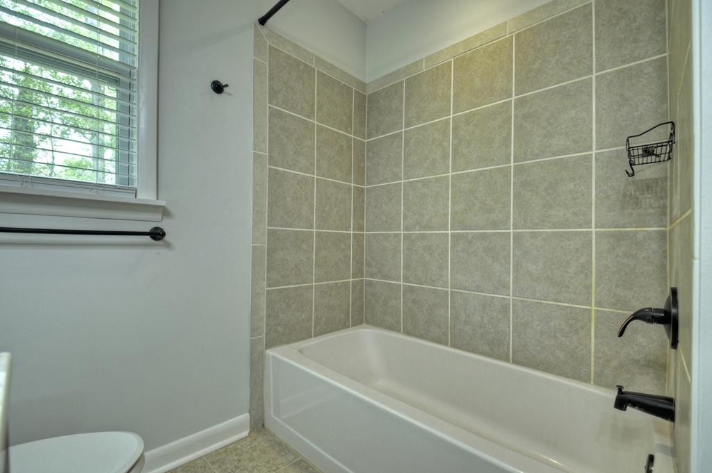 870-868 Sugar Creek Road Blue Ridge, GA 30513 - Photo 8 of 84 a white bath tub sitting next to a toilet