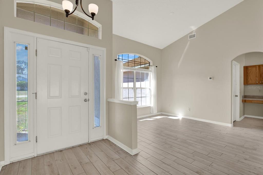 4400 Dior Road Spring Hill, FL 34609 - Photo 4 of 37 a view of empty room with wooden floor