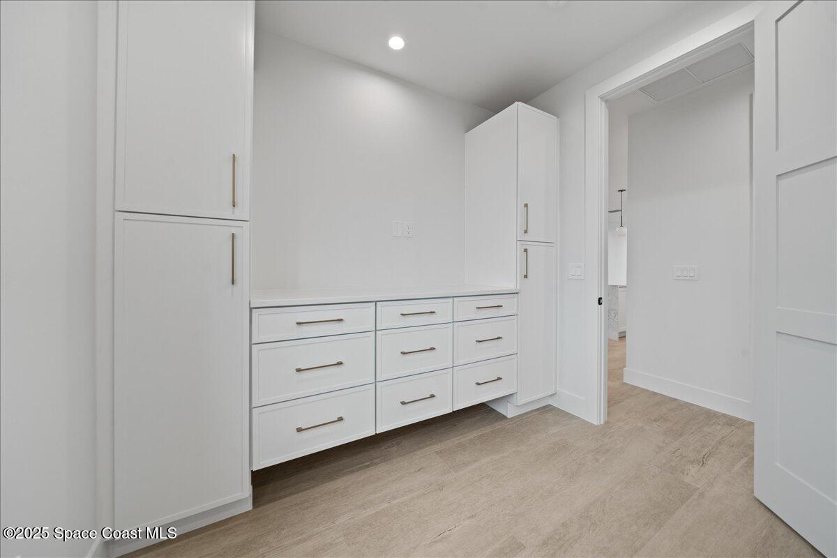 1004 Wave Crest Avenue Indialantic, FL 32903 - Photo 20 of 51 a room with white cabinets and wooden floors