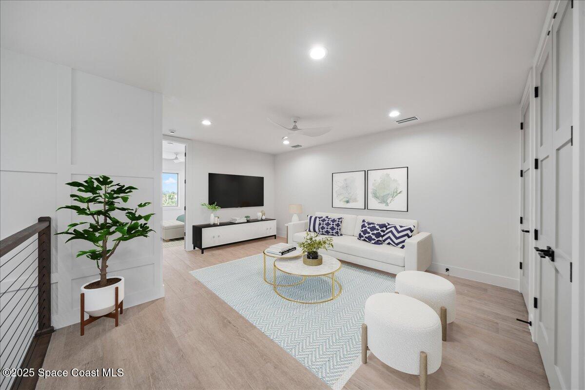 1004 Wave Crest Avenue Indialantic, FL 32903 - Photo 24 of 51 a living room with furniture potted plant and a flat screen tv