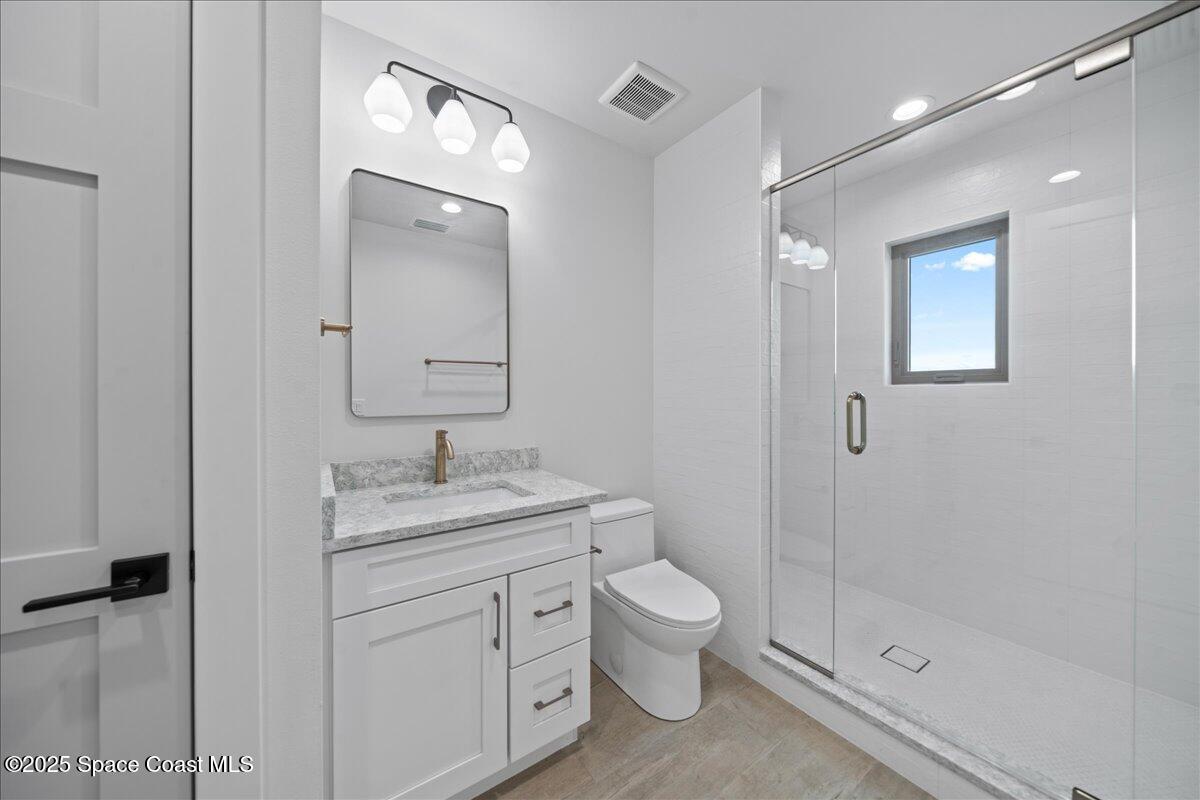 1004 Wave Crest Avenue Indialantic, FL 32903 - Photo 33 of 51 a bathroom with a sink a toilet and shower