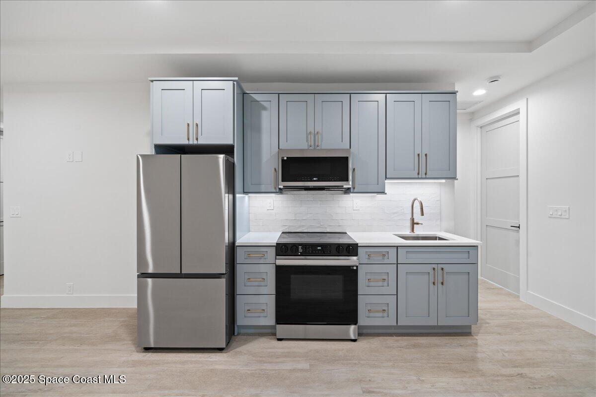 1004 Wave Crest Avenue Indialantic, FL 32903 - Photo 35 of 51 a kitchen with a sink a stove and refrigerator