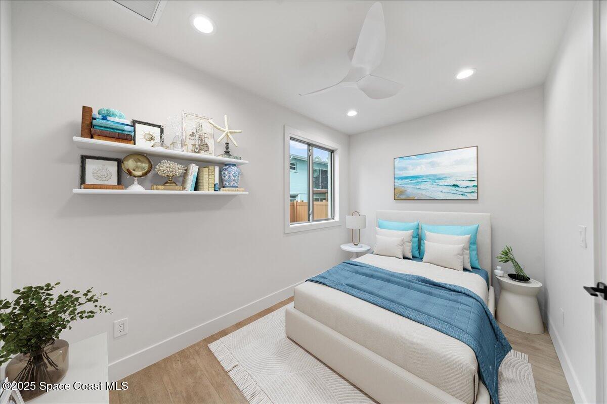1004 Wave Crest Avenue Indialantic, FL 32903 - Photo 38 of 51 a bedroom with a bed and a painting on the wall