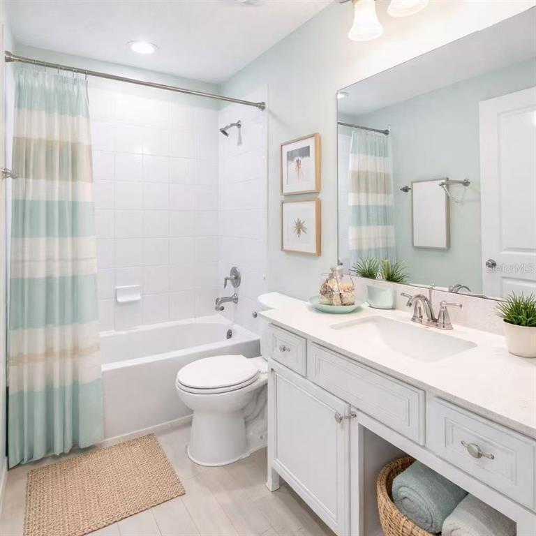 10379 Folly Beach Road Orlando, FL 32827 - Photo 12 of 54 a bathroom with a double vanity sink toilet and shower