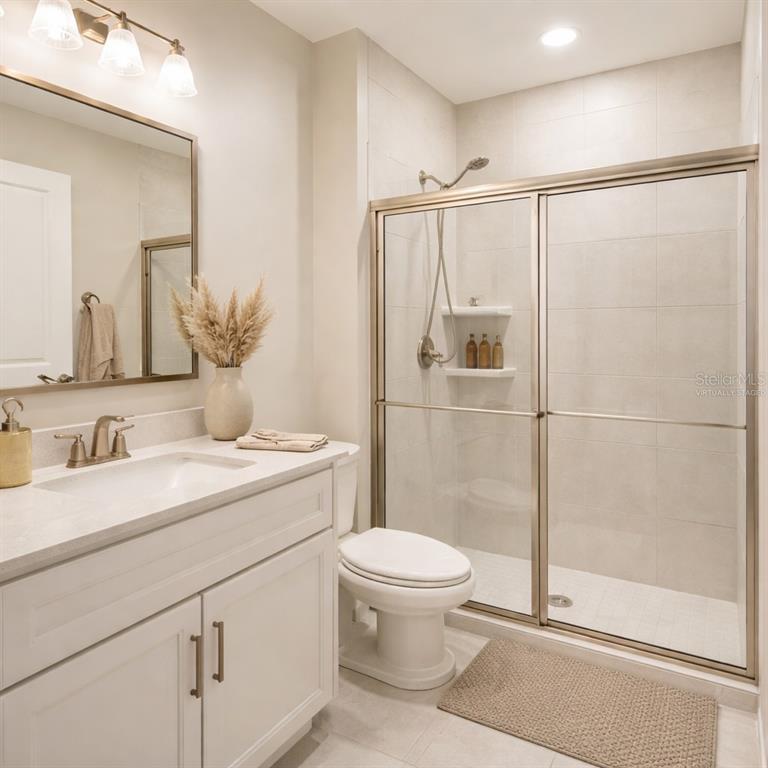 10379 Folly Beach Road Orlando, FL 32827 - Photo 12 of 56 a bathroom with a granite countertop sink toilet and shower