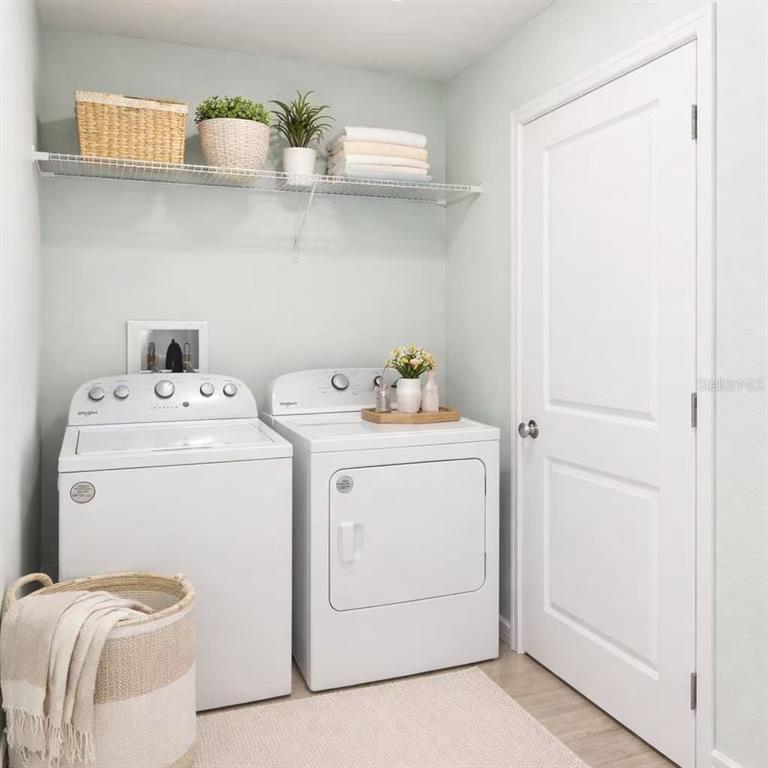 10379 Folly Beach Road Orlando, FL 32827 - Photo 14 of 54 a utility room with dryer and washer