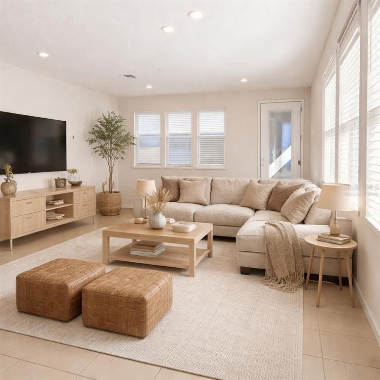 10379 Folly Beach Road Orlando, FL 32827 - Photo 2 of 56 a living room with furniture a flat screen tv and a large window