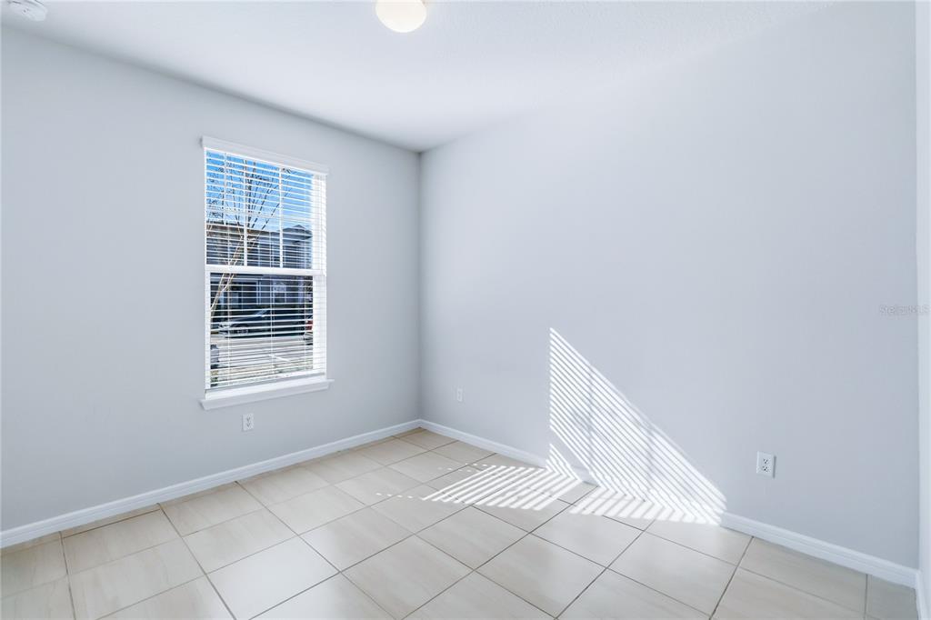 10379 Folly Beach Road Orlando, FL 32827 - Photo 23 of 54 a view of an empty room with wooden floor and a window
