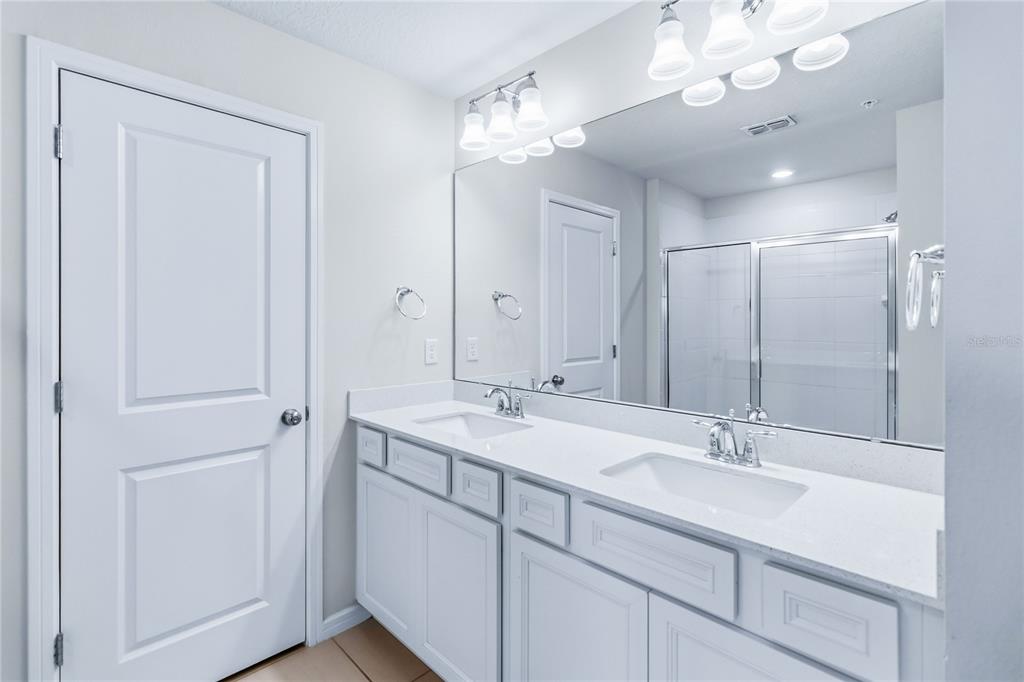 10379 Folly Beach Road Orlando, FL 32827 - Photo 32 of 56 a bathroom with a sink double vanity and a mirror