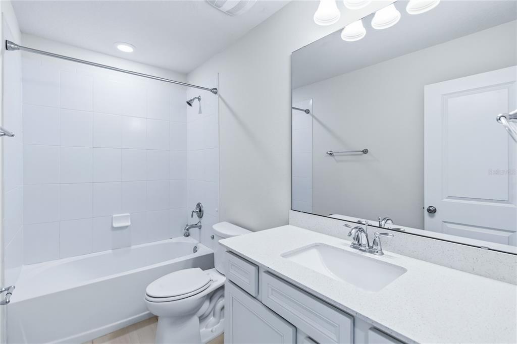 10379 Folly Beach Road Orlando, FL 32827 - Photo 35 of 54 a bathroom with a sink toilet tub and shower