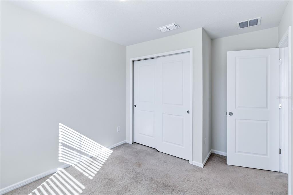 10379 Folly Beach Road Orlando, FL 32827 - Photo 38 of 54 a view of a room with wooden floor and closet