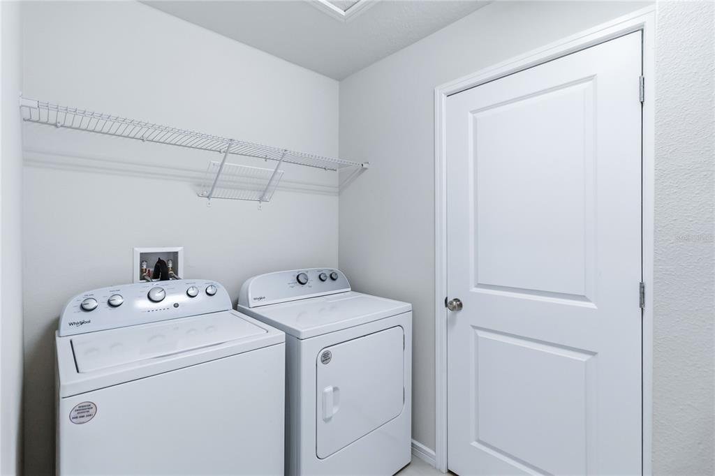 10379 Folly Beach Road Orlando, FL 32827 - Photo 39 of 56 a utility room with dryer and washer