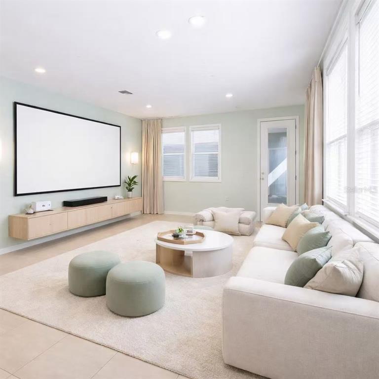 10379 Folly Beach Road Orlando, FL 32827 - Photo 5 of 54 a living room with furniture and a flat screen tv