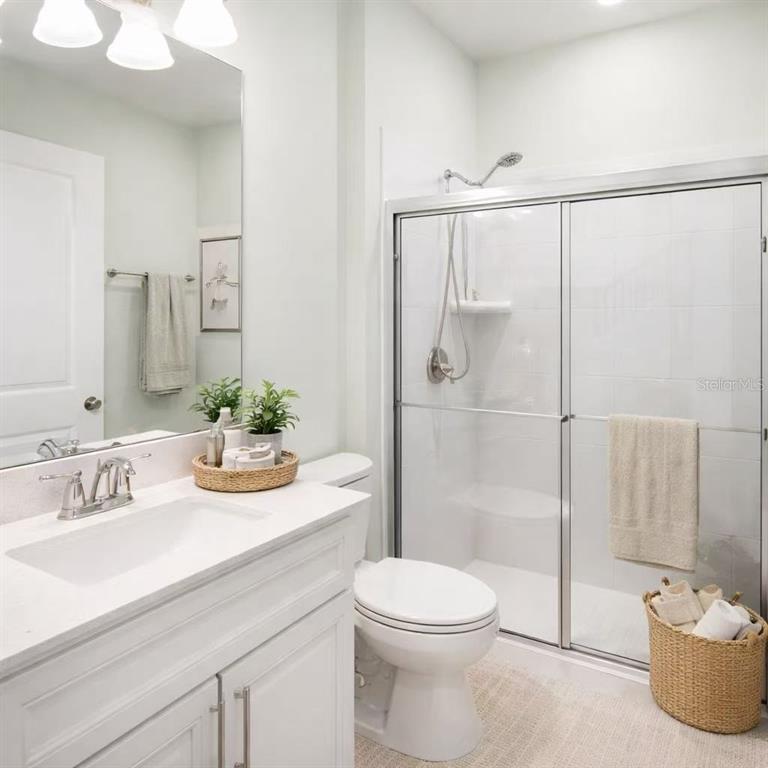 10379 Folly Beach Road Orlando, FL 32827 - Photo 7 of 54 a bathroom with a granite countertop sink a toilet and shower