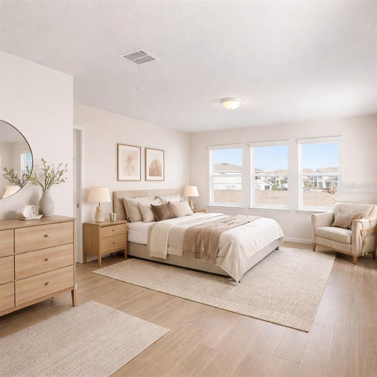 10379 Folly Beach Road Orlando, FL 32827 - Photo 10 of 56 a spacious bedroom with a bed and a couch