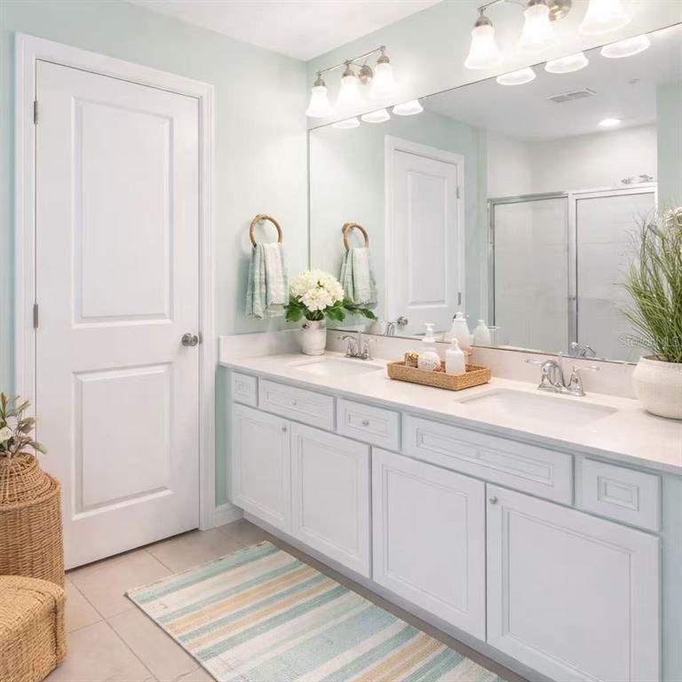 10379 Folly Beach Road Orlando, FL 32827 - Photo 10 of 54 a bathroom with a double vanity sink and a mirror