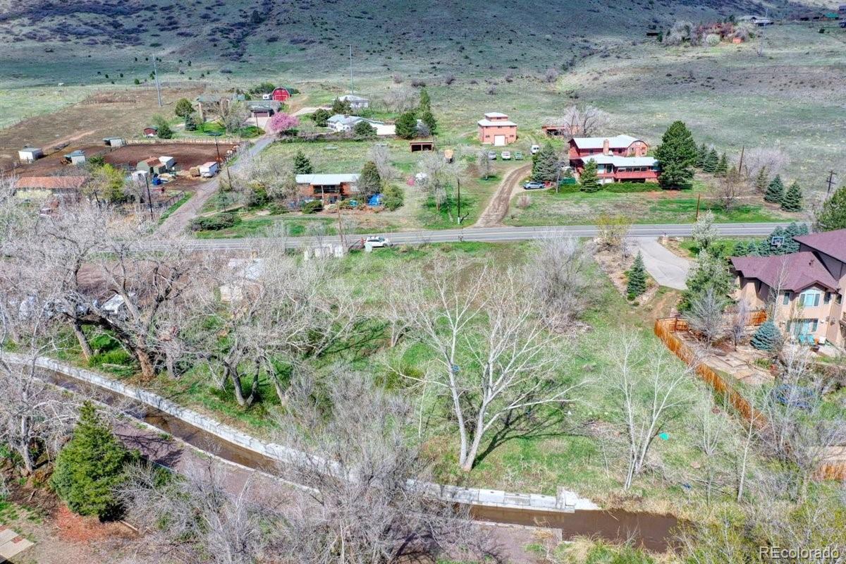 5070 Easley Road Golden, CO 80403 - Photo 7 of 24 a utility room with toys and a wooden fence