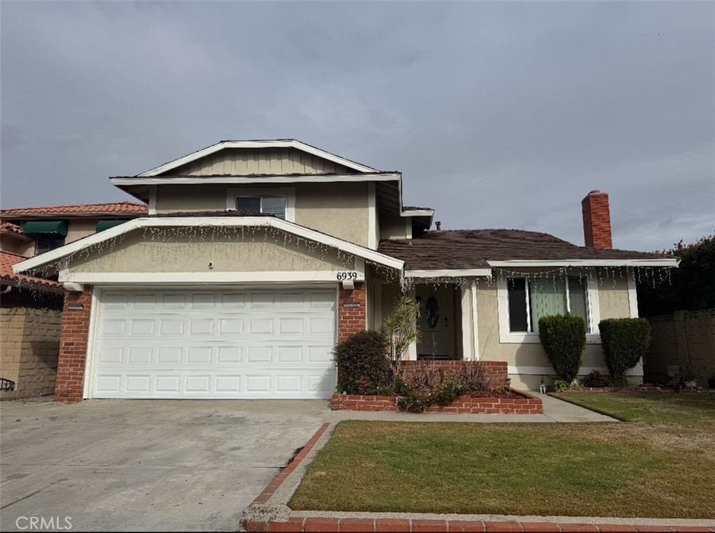 6939 Tahiti Drive Cypress, CA 90630 - Photo 14 of 15 a front view of a house with a yard