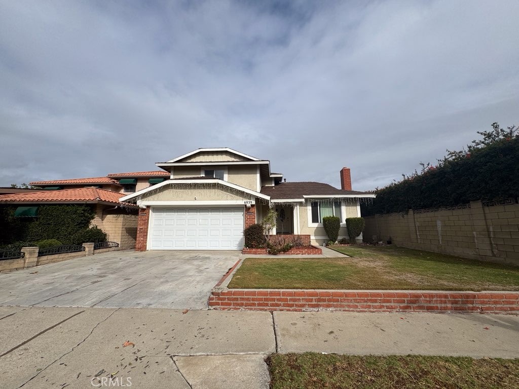 6939 Tahiti Drive Cypress, CA 90630 - Photo 15 of 15 a front view of a house with a yard