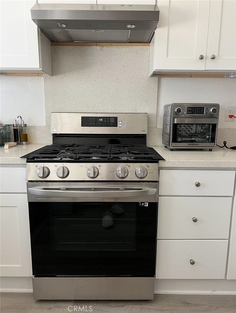 6939 Tahiti Drive Cypress, CA 90630 - Photo 3 of 15 a stove top oven sitting inside of a kitchen