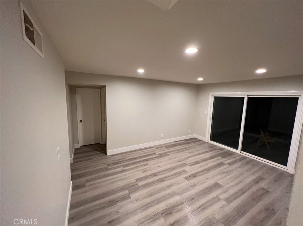 6939 Tahiti Drive Cypress, CA 90630 - Photo 7 of 15 a view of an empty room with wooden floor and closet