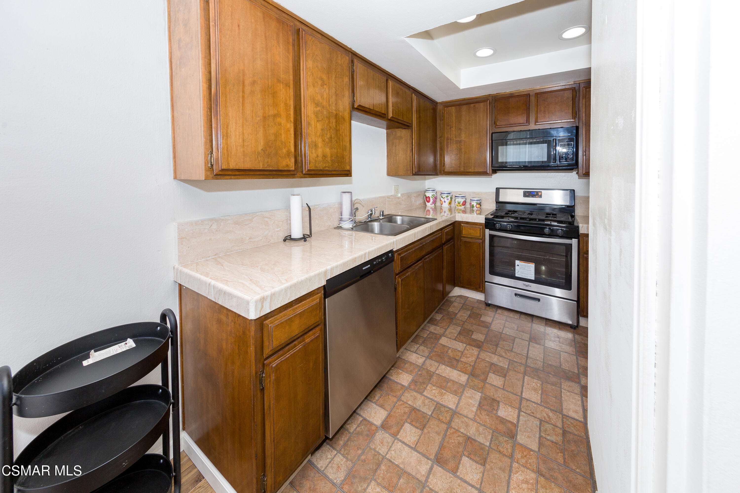 511 Spring Road, Unit 8 Moorpark, CA 93021 - Photo 6 of 17 a kitchen with stainless steel appliances granite countertop a sink stove and cabinets