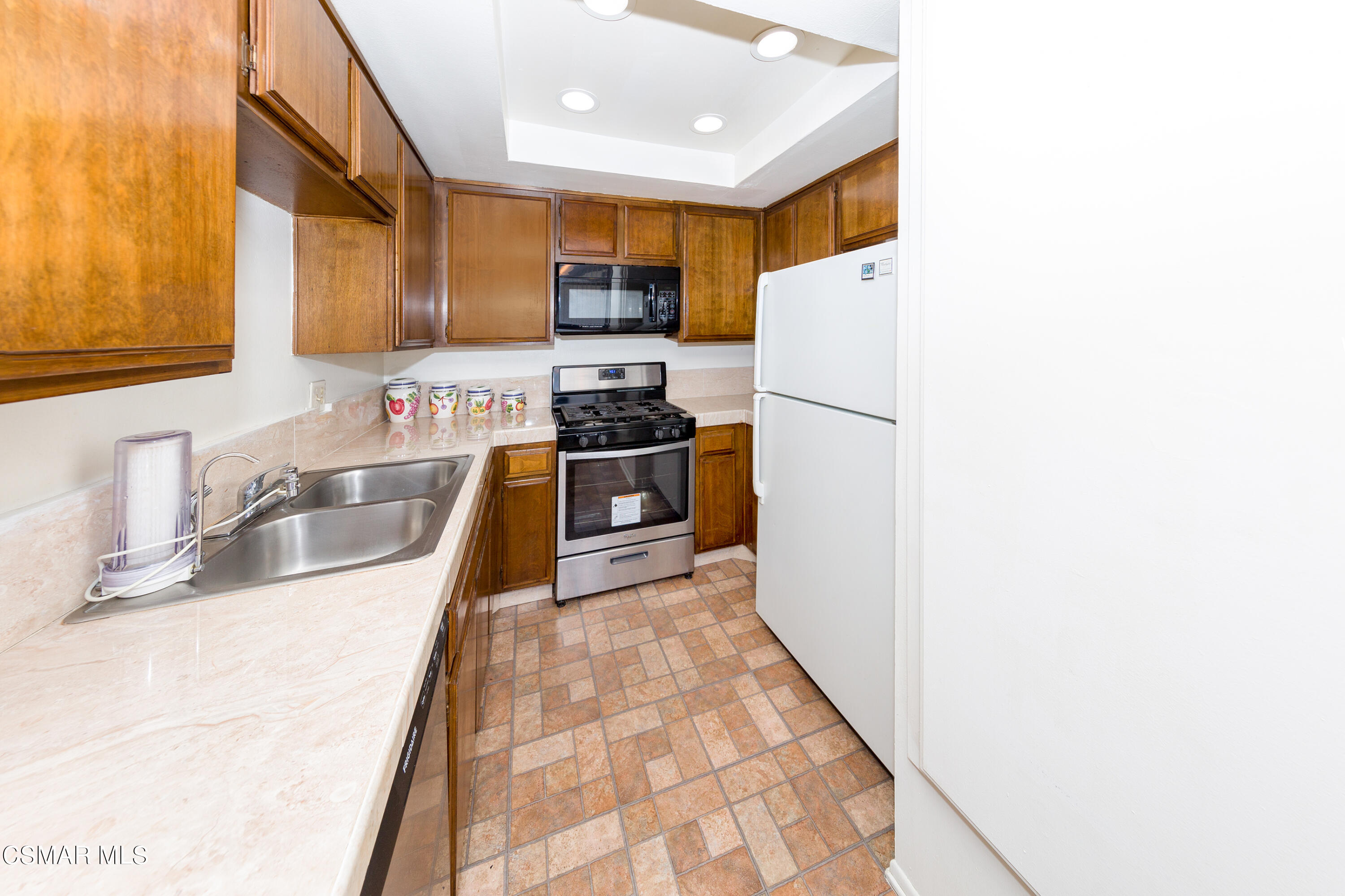 511 Spring Road, Unit 8 Moorpark, CA 93021 - Photo 7 of 17 a kitchen with stainless steel appliances granite countertop a sink a stove a refrigerator with grey cabinets