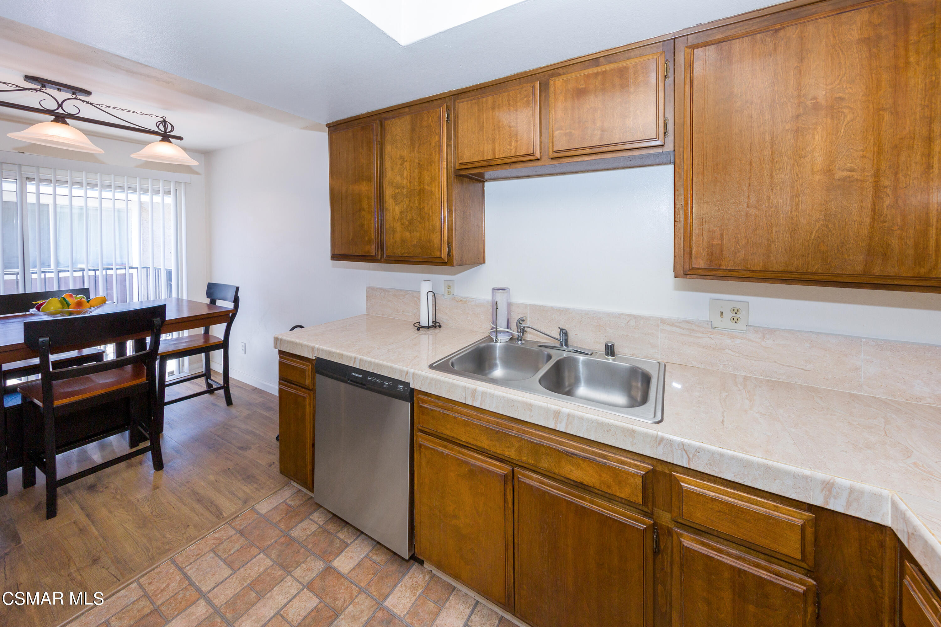 511 Spring Road, Unit 8 Moorpark, CA 93021 - Photo 8 of 17 a kitchen with stainless steel appliances granite countertop a sink dishwasher stove and cabinets with wooden floor