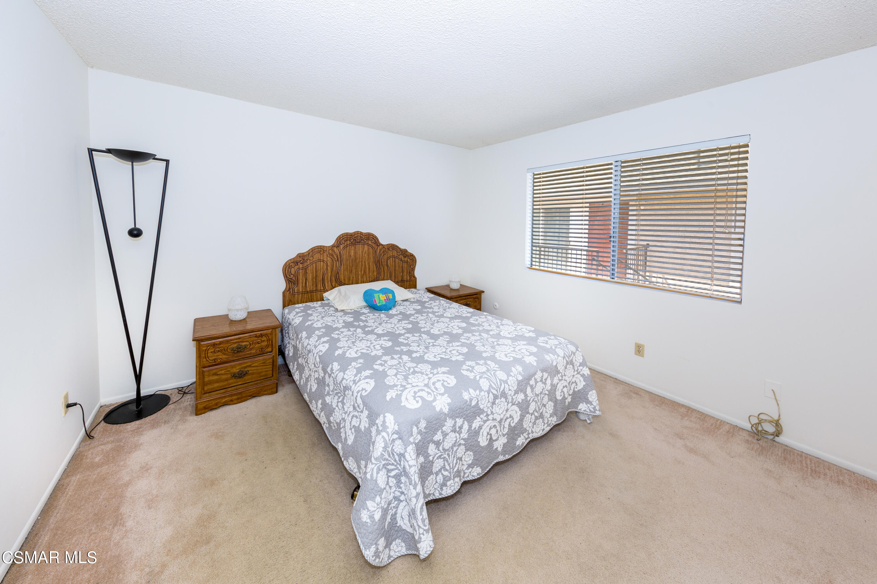 511 Spring Road, Unit 8 Moorpark, CA 93021 - Photo 9 of 17 a bed sitting in a bedroom next to a window