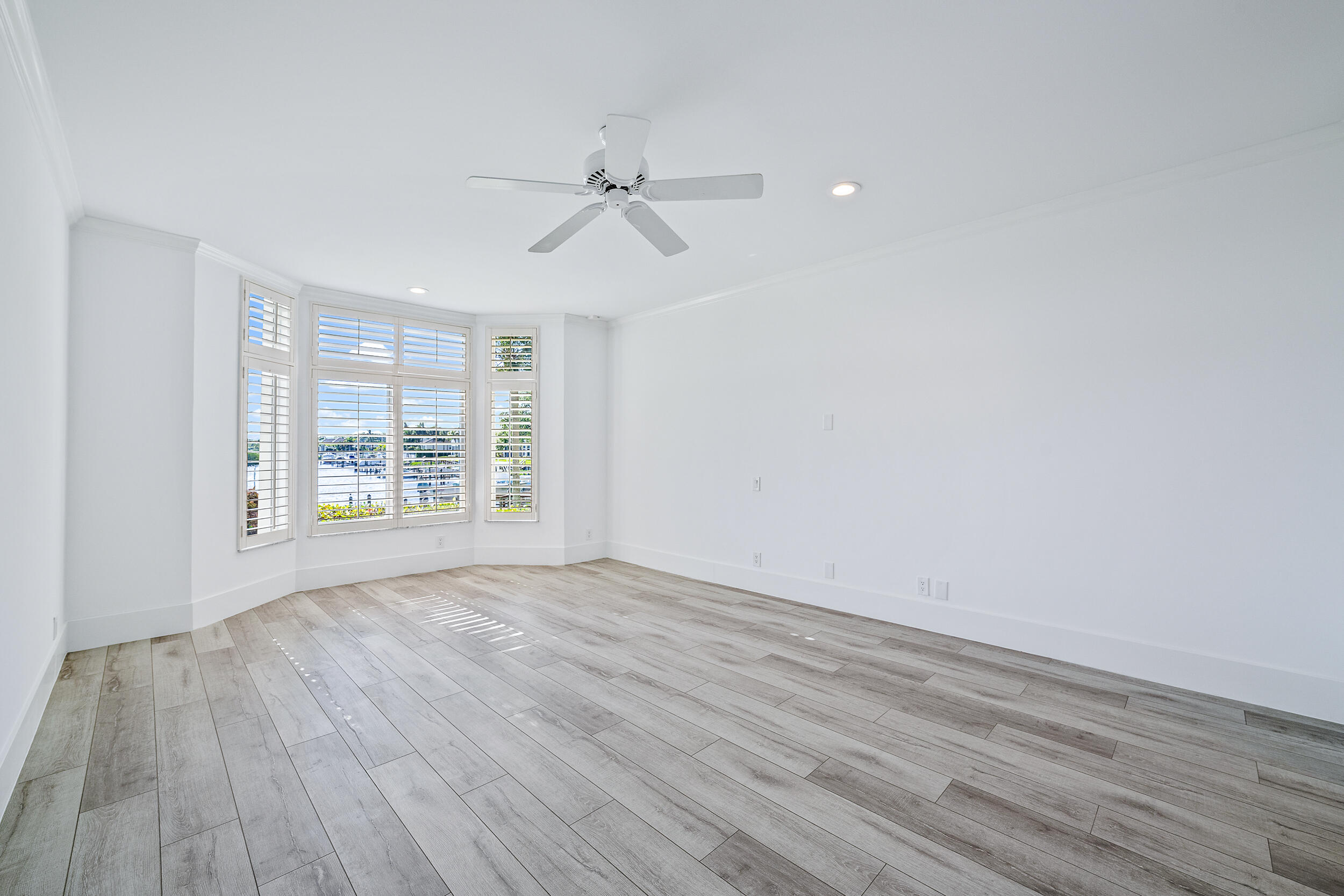 226 Eagle Drive Jupiter, FL 33477 - Photo 18 of 31 a view of an empty room with wooden floor and a window