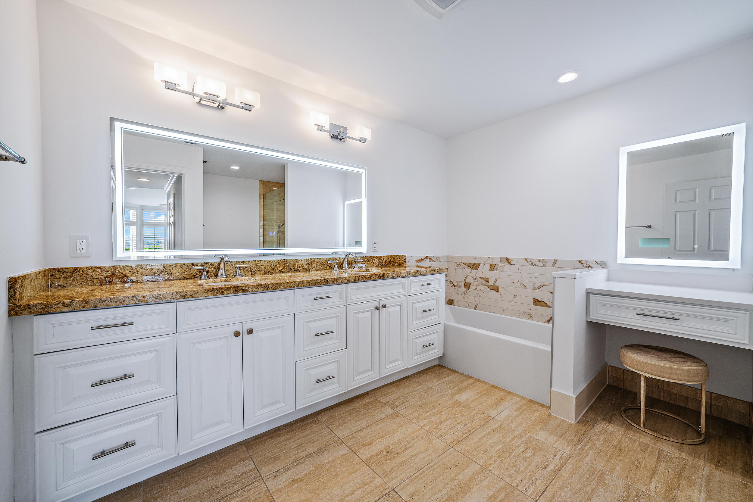 226 Eagle Drive Jupiter, FL 33477 - Photo 19 of 31 a spacious bathroom with a granite countertop sink and a mirror