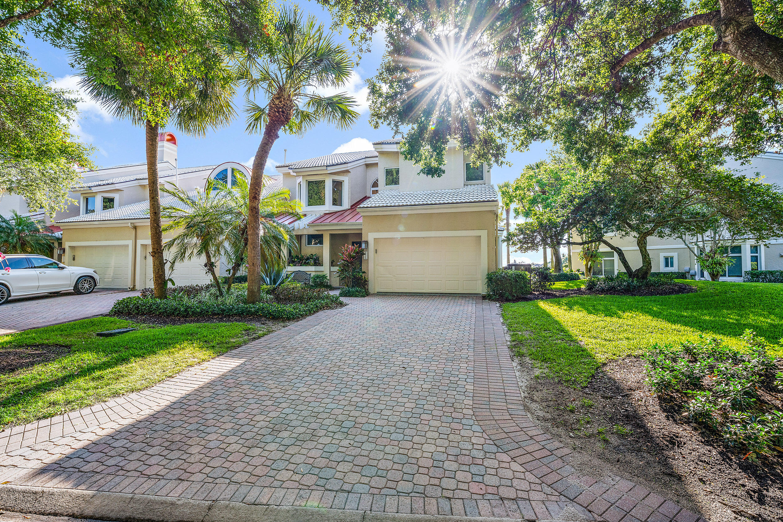 226 Eagle Drive Jupiter, FL 33477 - Photo 3 of 31 a front view of a house with a yard and a garage