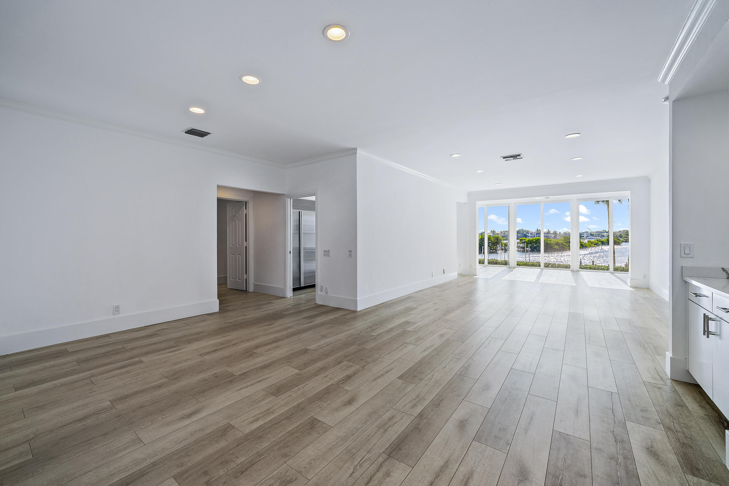 226 Eagle Drive Jupiter, FL 33477 - Photo 5 of 31 a view of a big room with wooden floor and windows