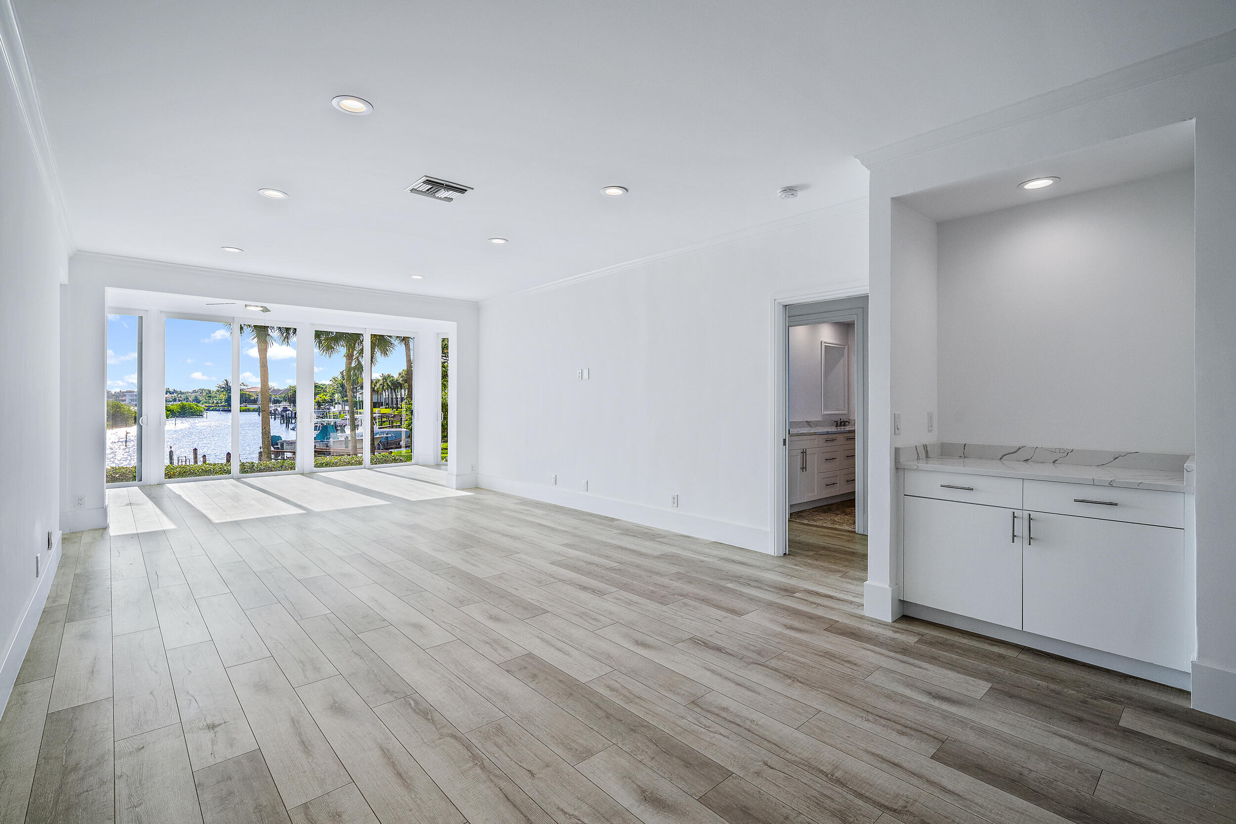 226 Eagle Drive Jupiter, FL 33477 - Photo 6 of 31 a view of an empty room with wooden floor and a window