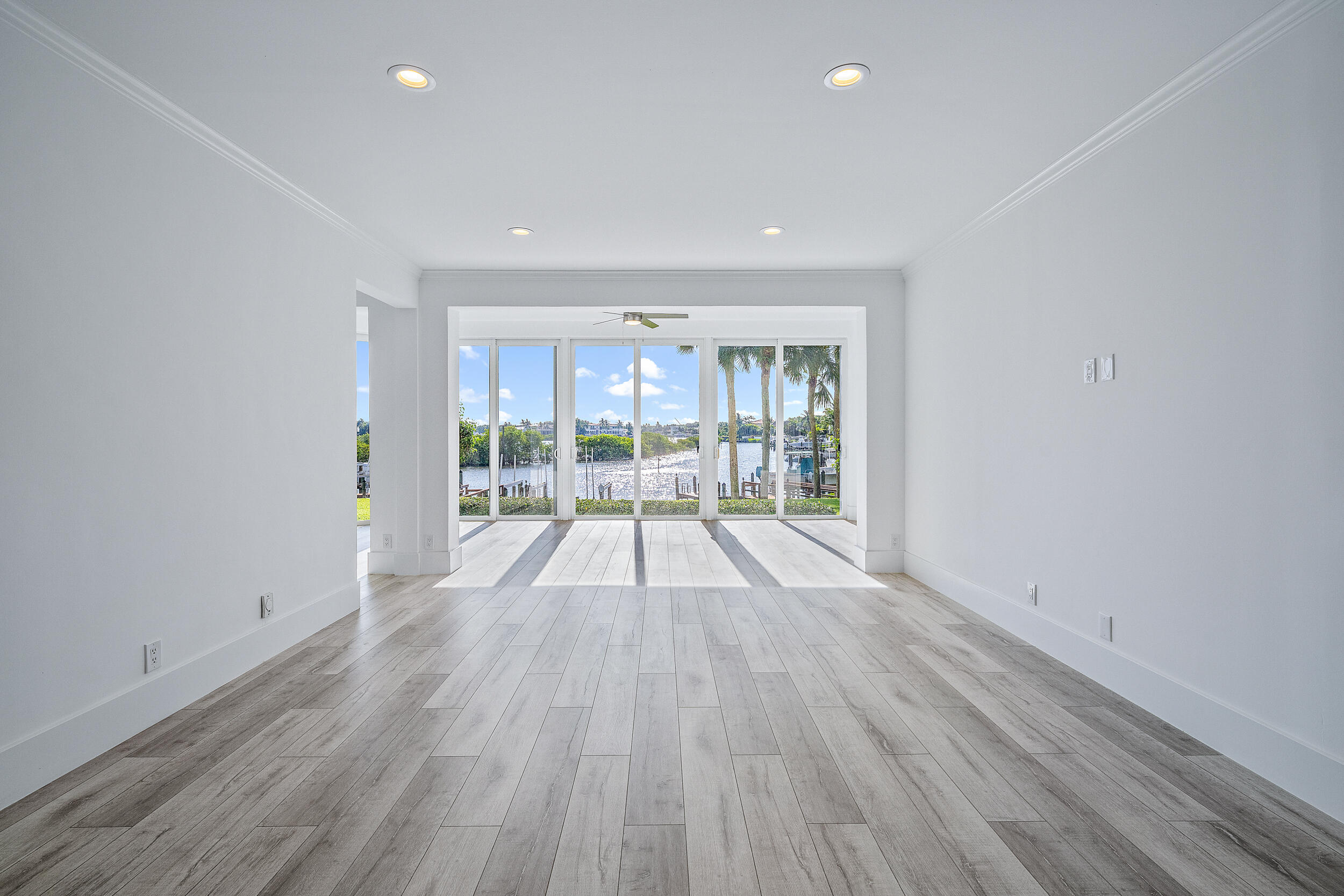 226 Eagle Drive Jupiter, FL 33477 - Photo 7 of 31 wooden floor in an empty room with a window